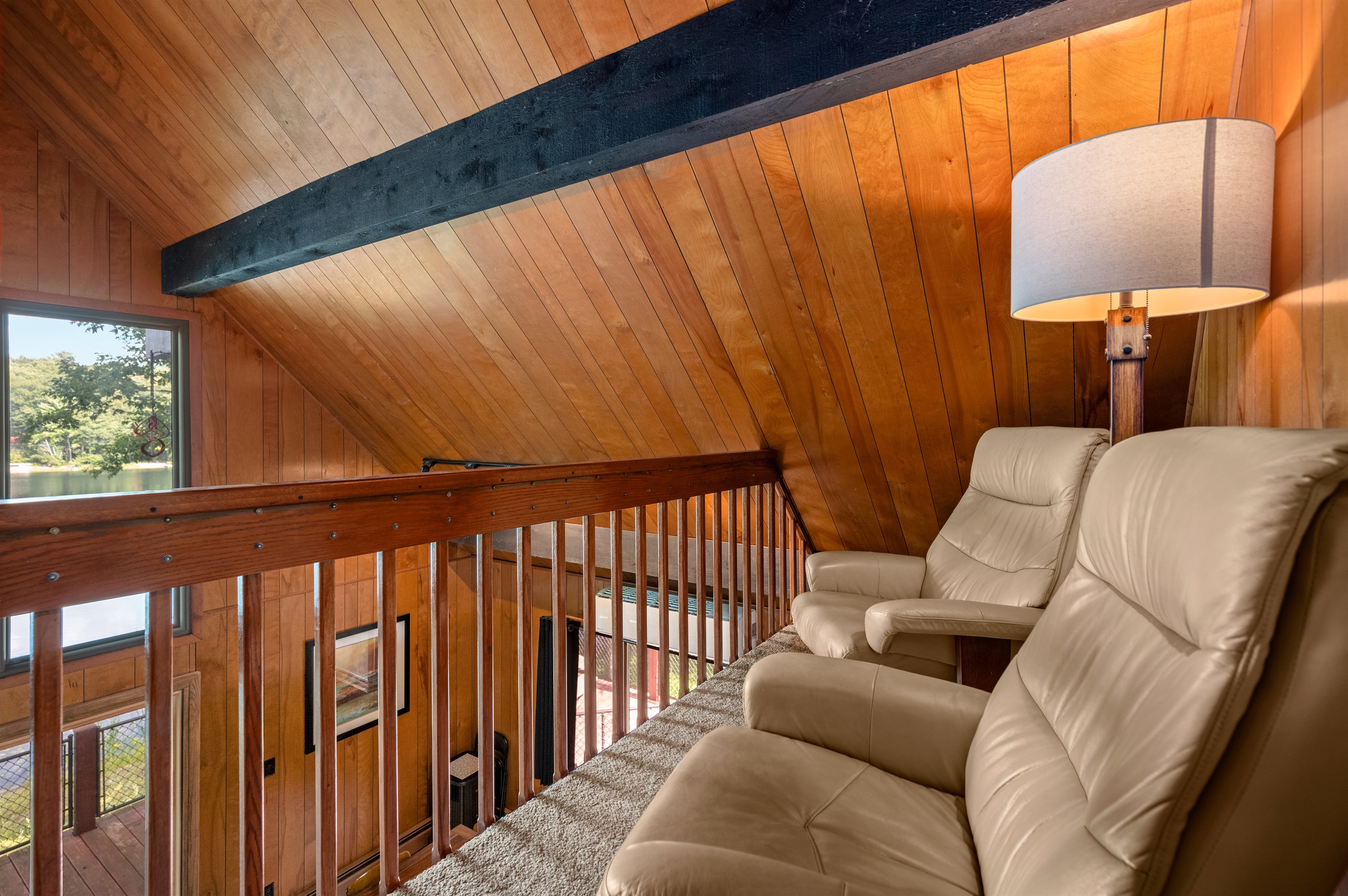 Upstairs loft with seating area overlooking the lake