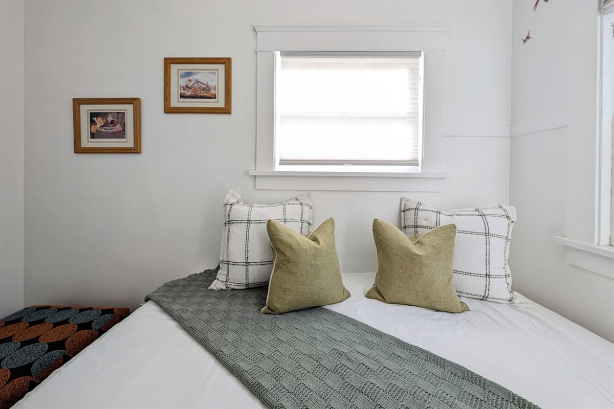 Cozy bonus room with twin bed, soft natural light, and a peaceful atmosphere.
