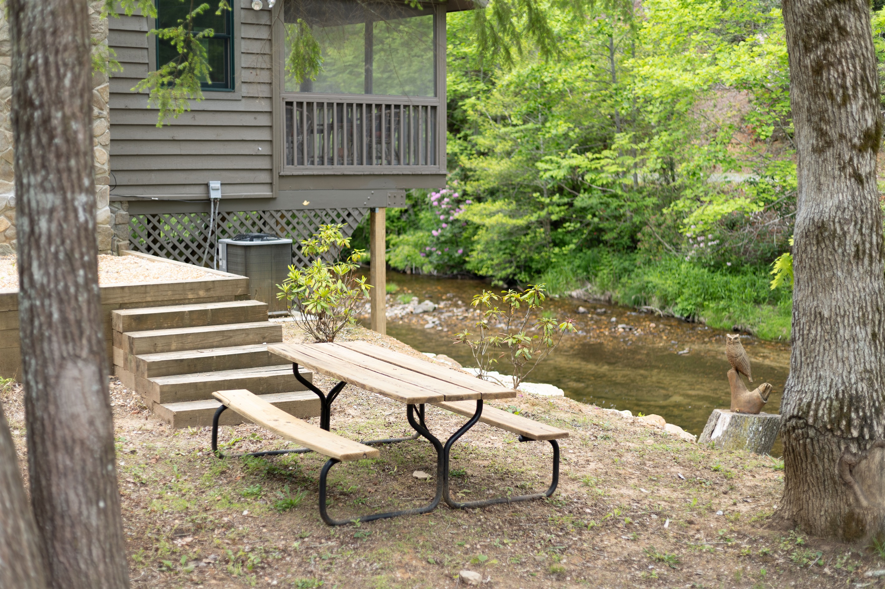 A second picnic table overlooking the creek creates the perfect spot for outdoor meals surrounded by the sounds of rushing water.