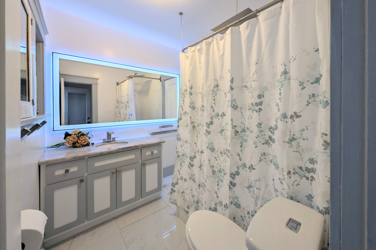 Refresh in a bright, spa-inspired bathroom featuring a spacious vanity, illuminated LED mirror, and a full shower/tub combination for ultimate comfort.