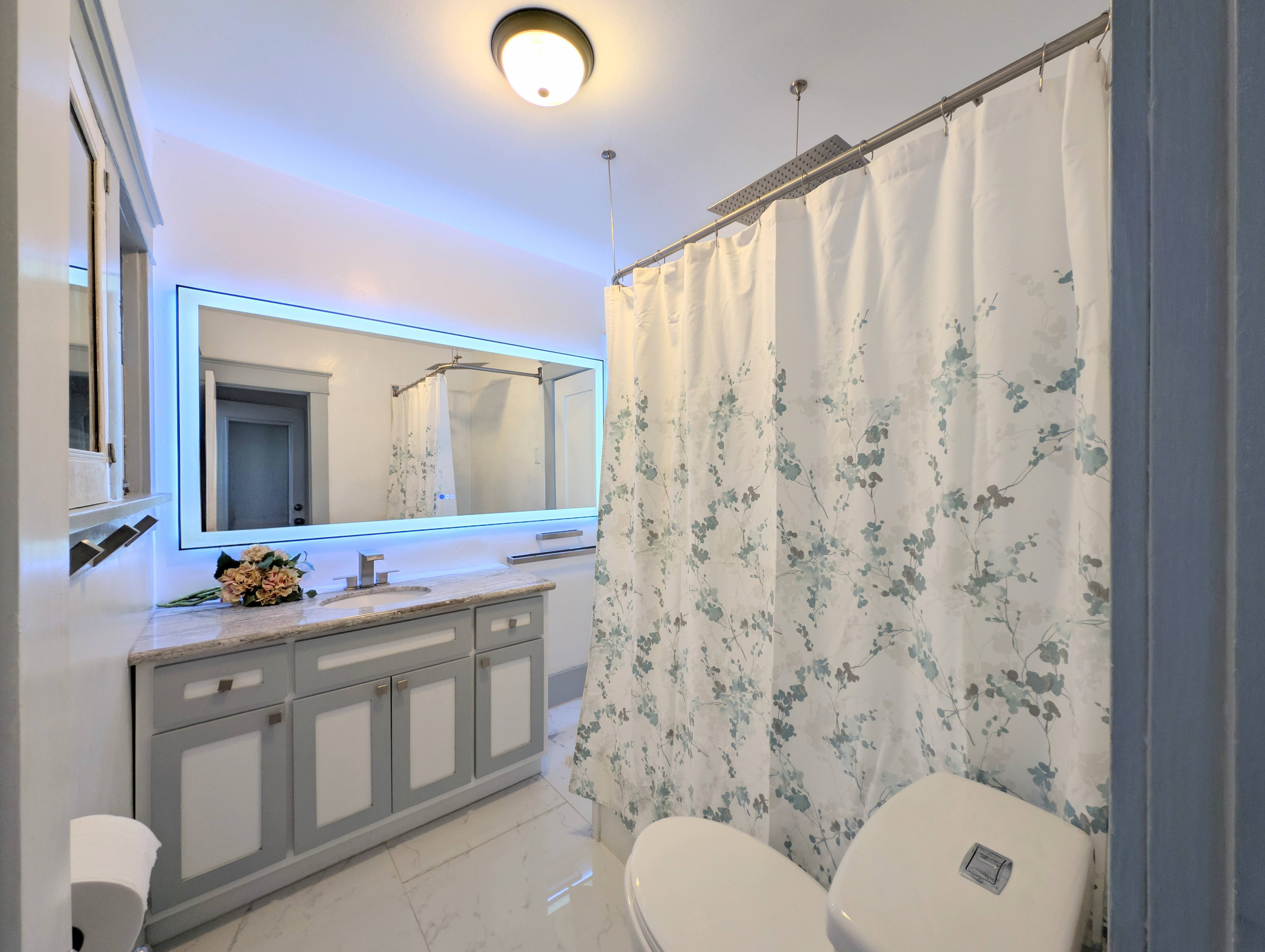 Refresh in a bright, spa-inspired bathroom featuring a spacious vanity, illuminated LED mirror, and a full shower/tub combination for ultimate comfort.