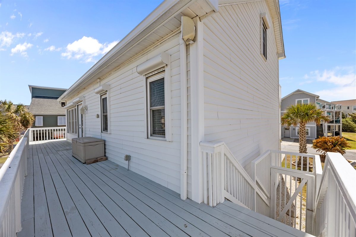 Private deck with outdoor storage and stairs leading to the ground level