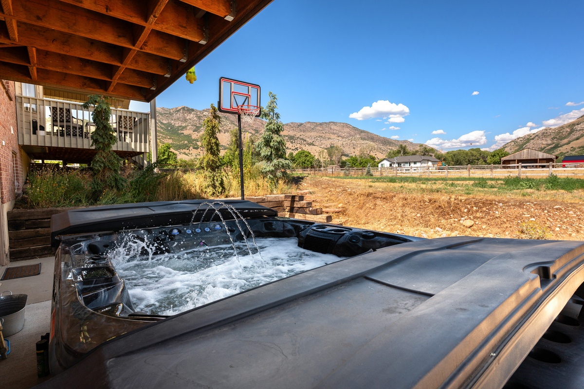 Soak in the bubbling hot tub with the basketball area and dramatic mountain scenery just beyond, creating the perfect balance of relaxation and recreation.