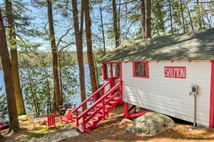 back view of the cabin, staring the stairs and the lake.