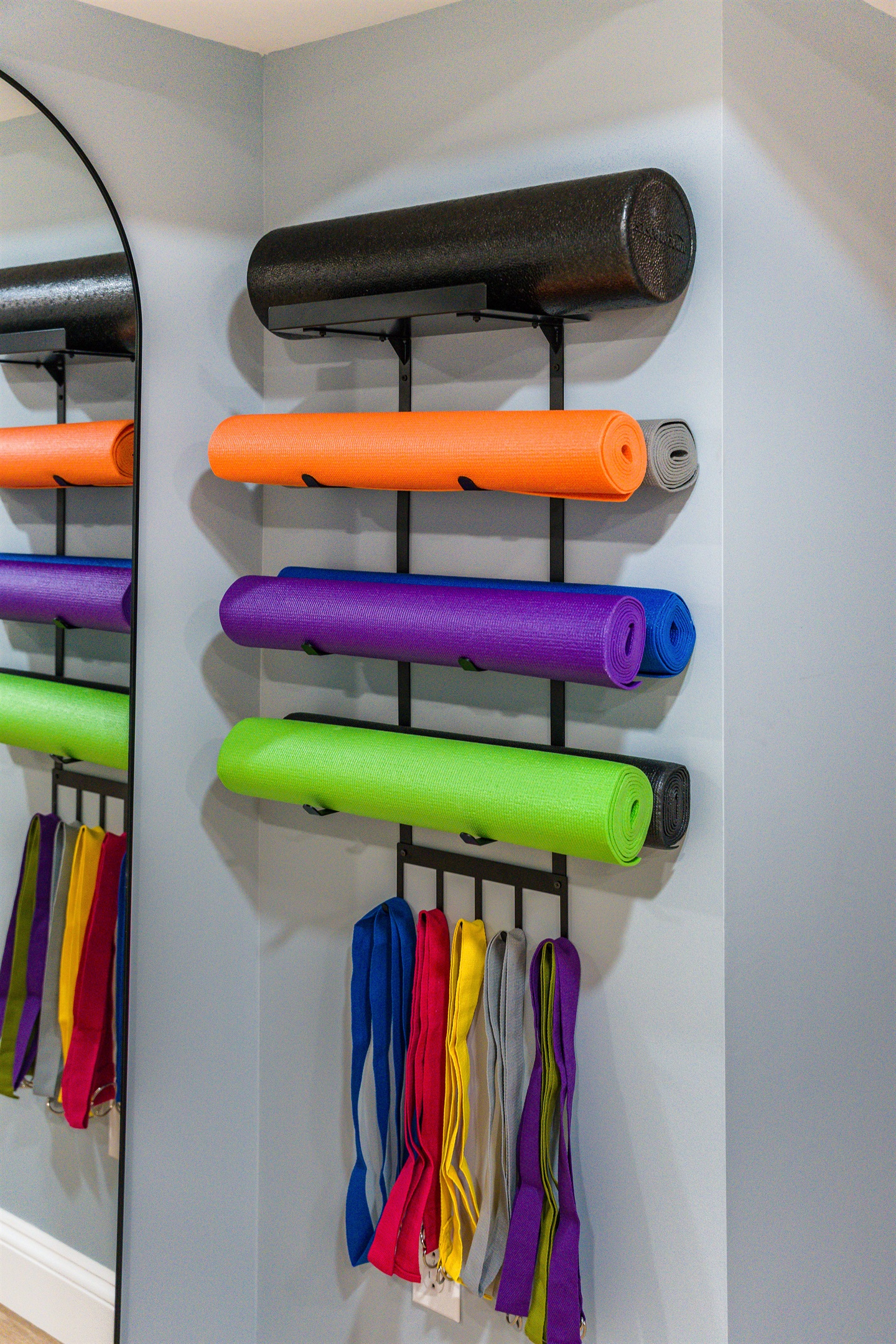Every detail is thought through—even the wall-mounted rack of mats and bands is guest-friendly and organized, making it easy for everyone in the group to grab what they need.