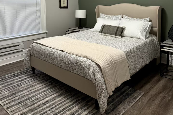 Sink into a plush queen bed layered with soft linens, ready for a night of deep, easy rest.