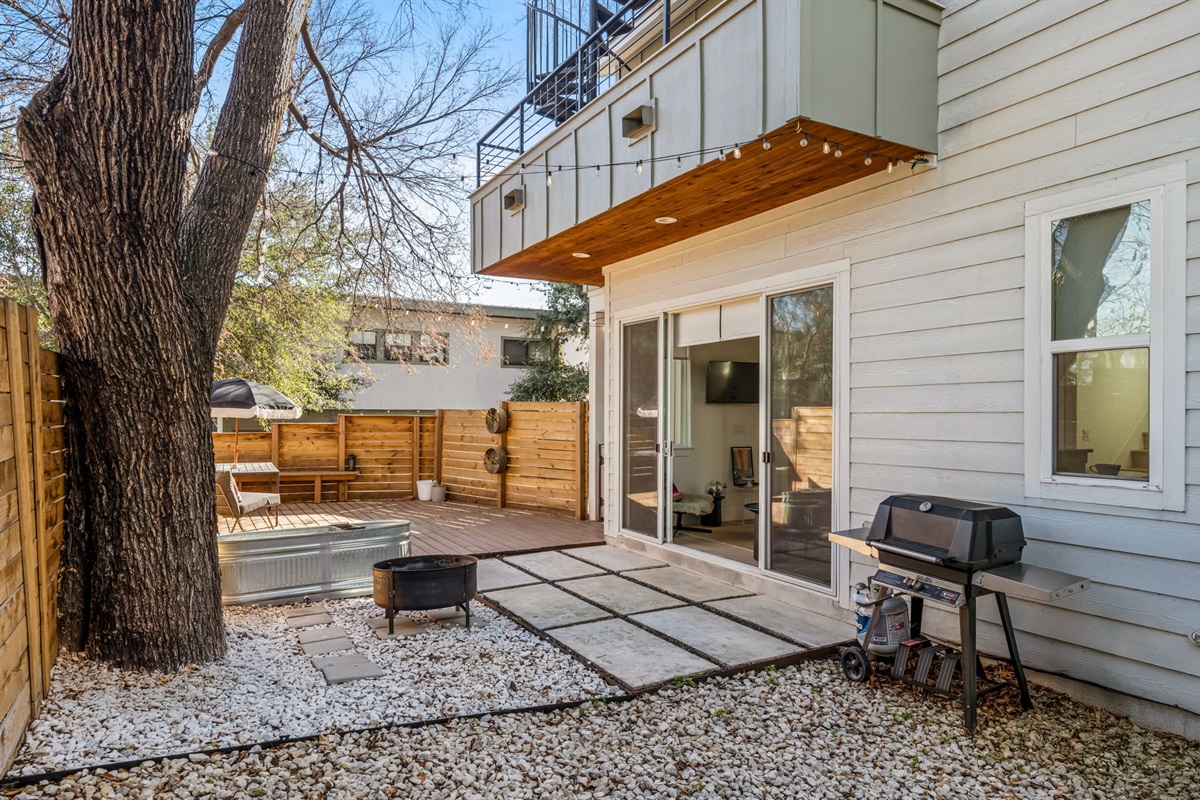 Private patio with outdoor seating and BBQ grill—perfect for relaxing or dining outside