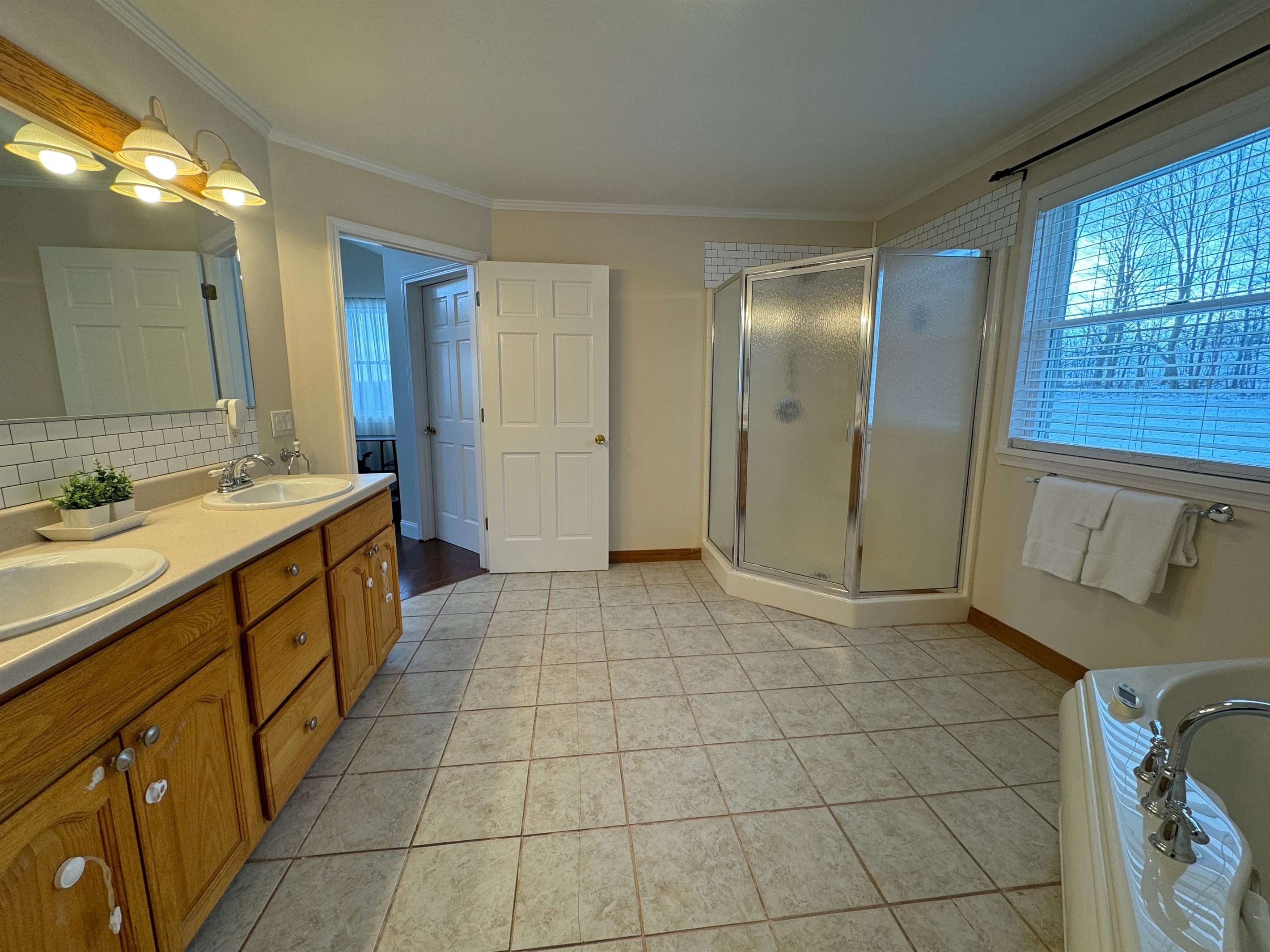 King primary ensuite bath with jetted tub and shower