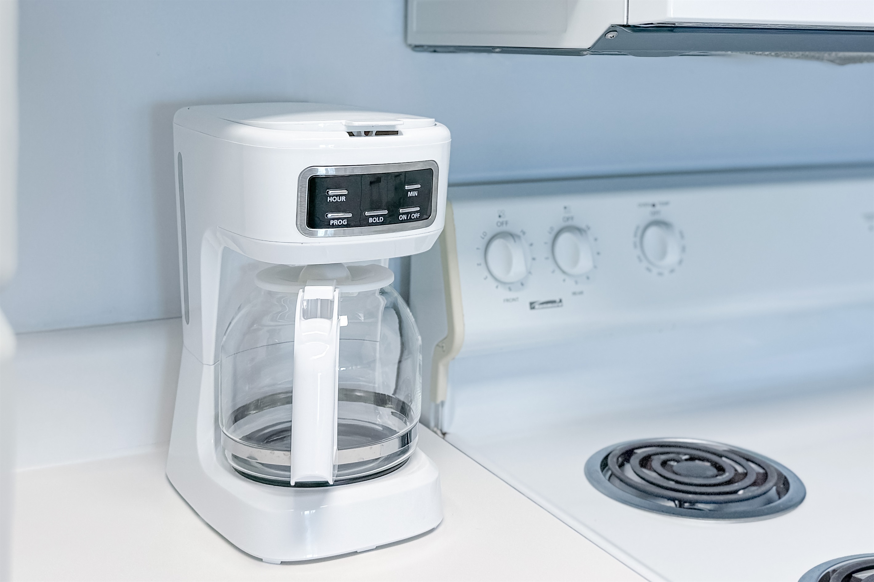 Whether you prefer a full pot or a quick single cup, this kitchen caters to all coffee lovers with both a traditional pot and a single-serve machine, plus other essential appliances.