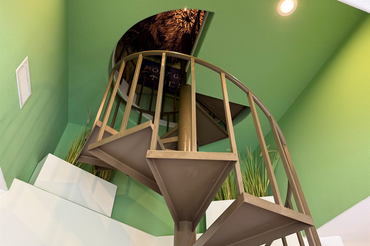 The indoor spiral staircase leads to the Best Rooftop Bar in all of Galveston!