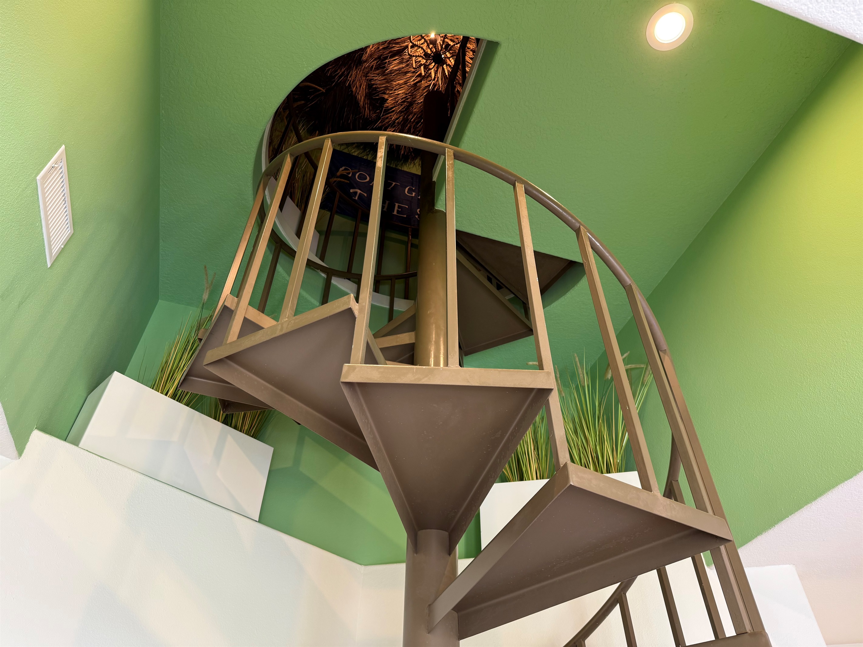 The indoor spiral staircase leads to the Best Rooftop Bar in all of Galveston!