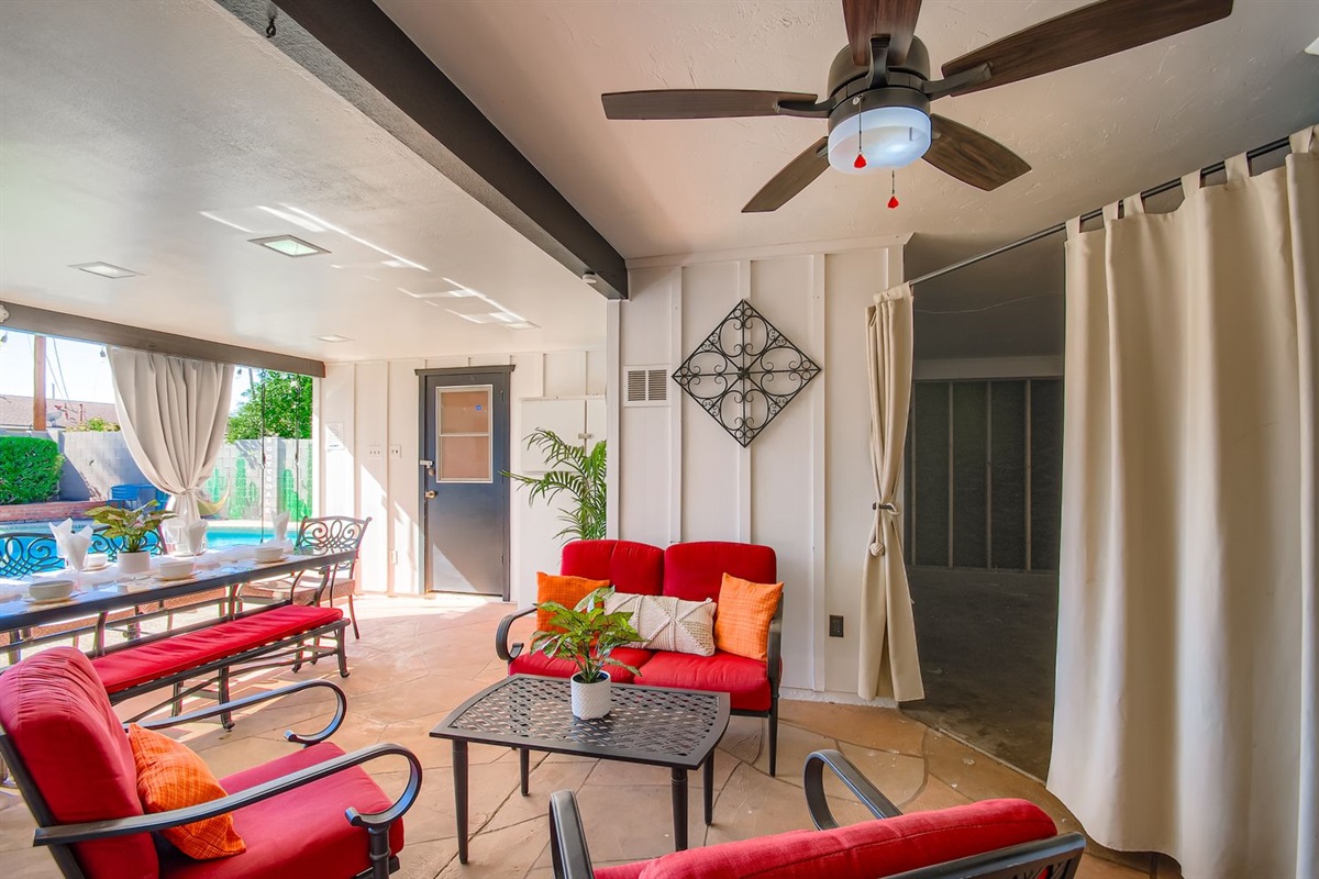 Patio seating by the outdoor TV.  Behind the curtain is a Spa Room coming January 2026