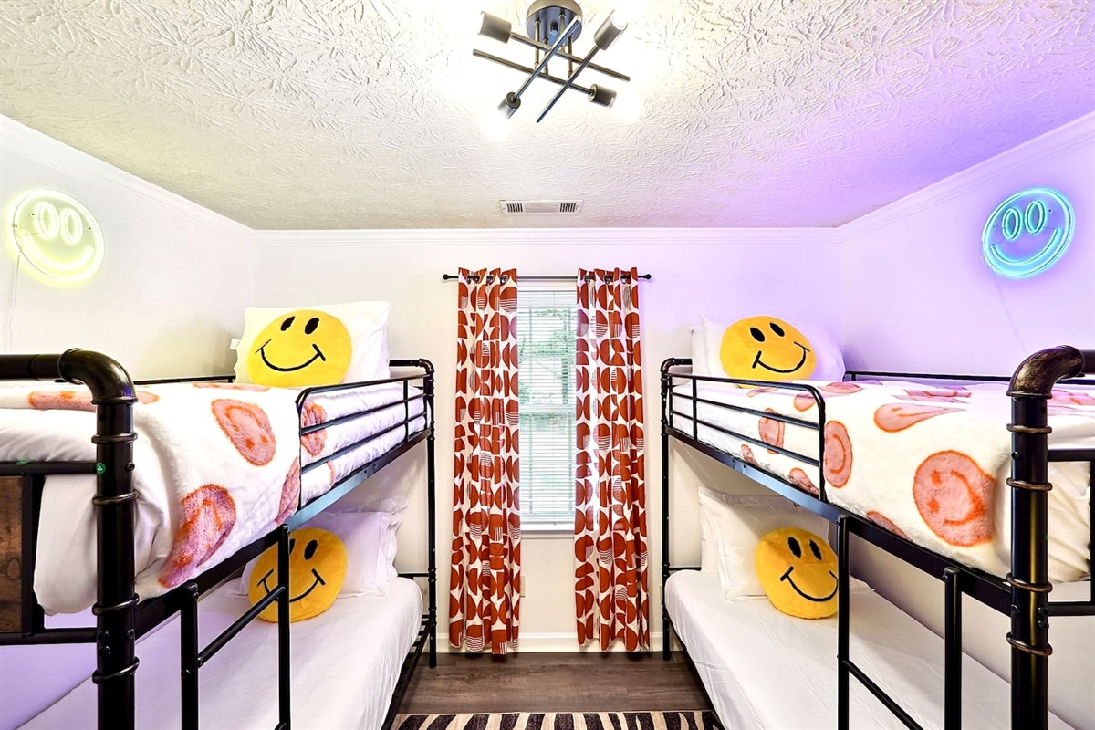 Bedroom 5 is located upstairs, features double bunk beds and a TV. This room does not have a private en-suite bathroom but has access to a shared bathroom.