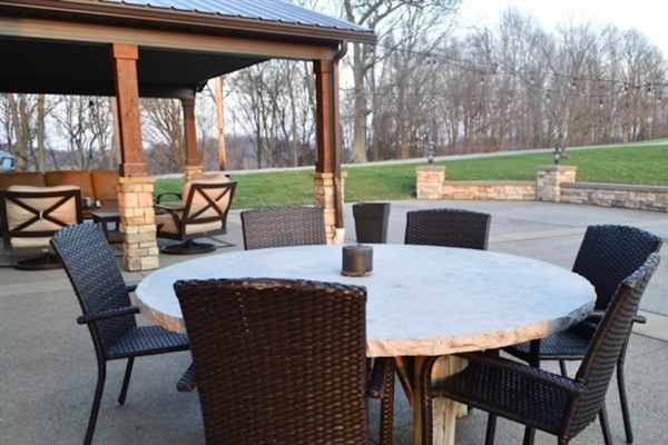 Outdoor dining with views of the patio and fire pit just steps away