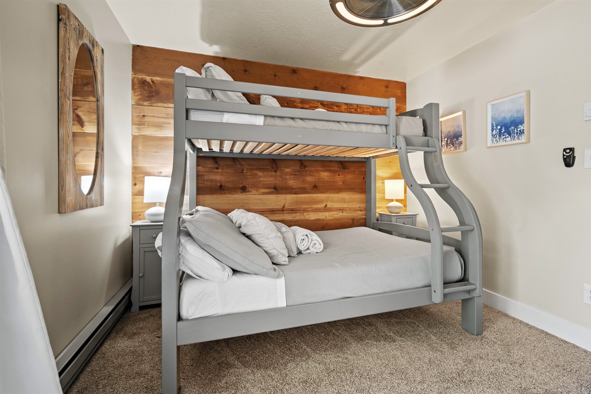 Bunk room perfect for kids or groups, featuring sturdy beds and cozy quilts.