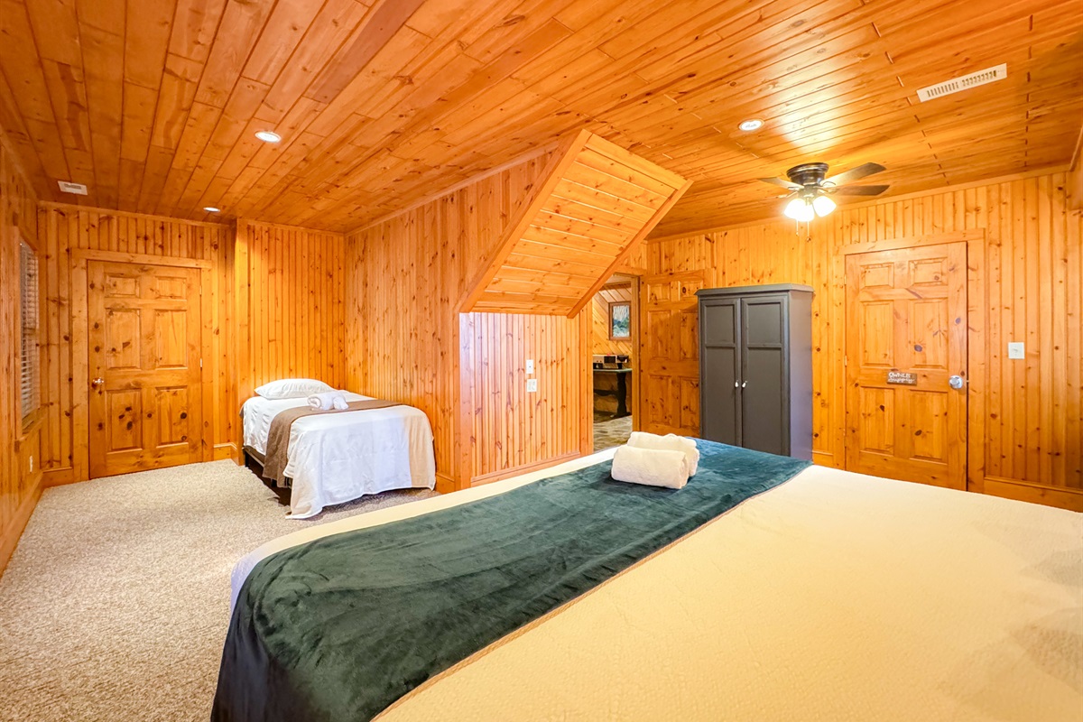 large lower level bedroom with a King Size bed and twin bed