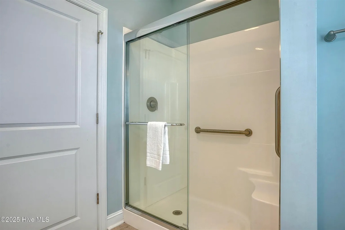 Modern walk-in shower with sleek glass door finishes