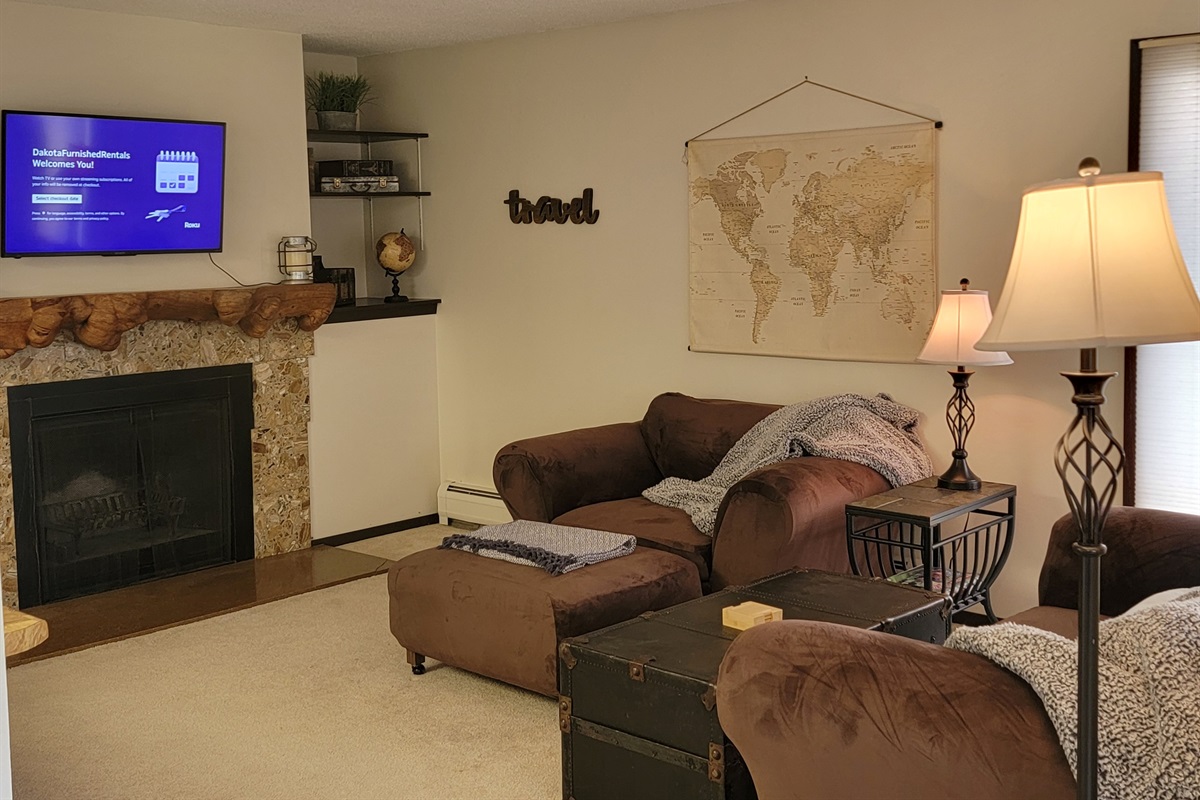 KP101APT5 - Living Room w/love seats, patio access, decorative fireplace, and Roku TV