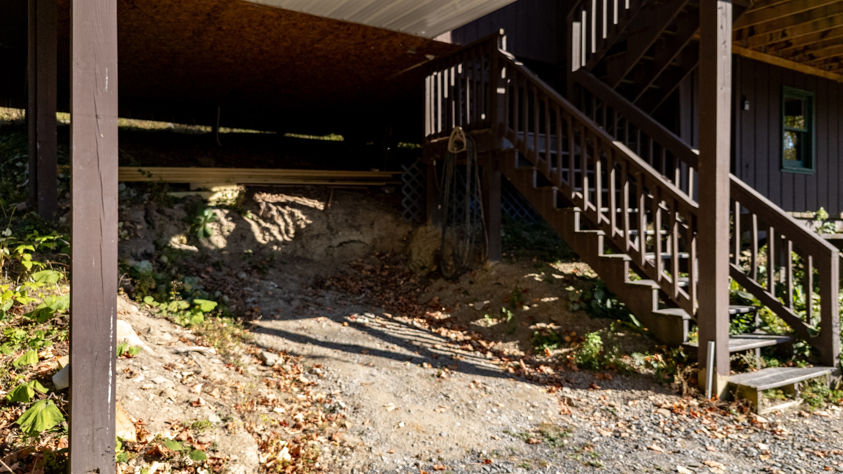 Deck stairs and skirt area beneath deck showing usable space.