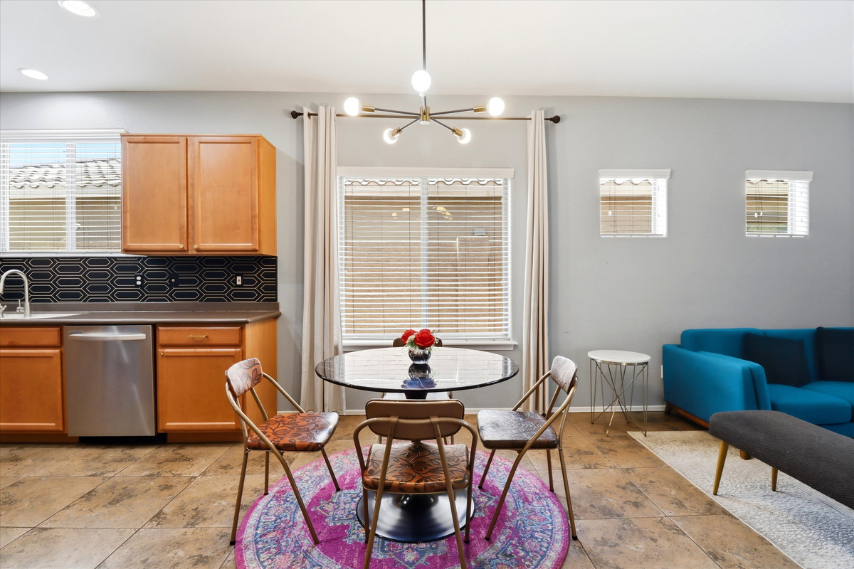 Dining nook with round table seating, kitchen access, and the living room right nearby.