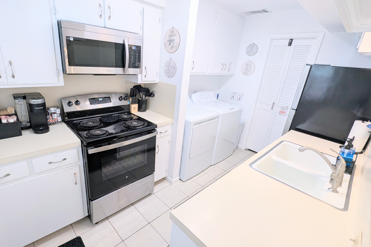 This fully equipped kitchen includes an electric stove and oven, along with a microwave for added convenience.