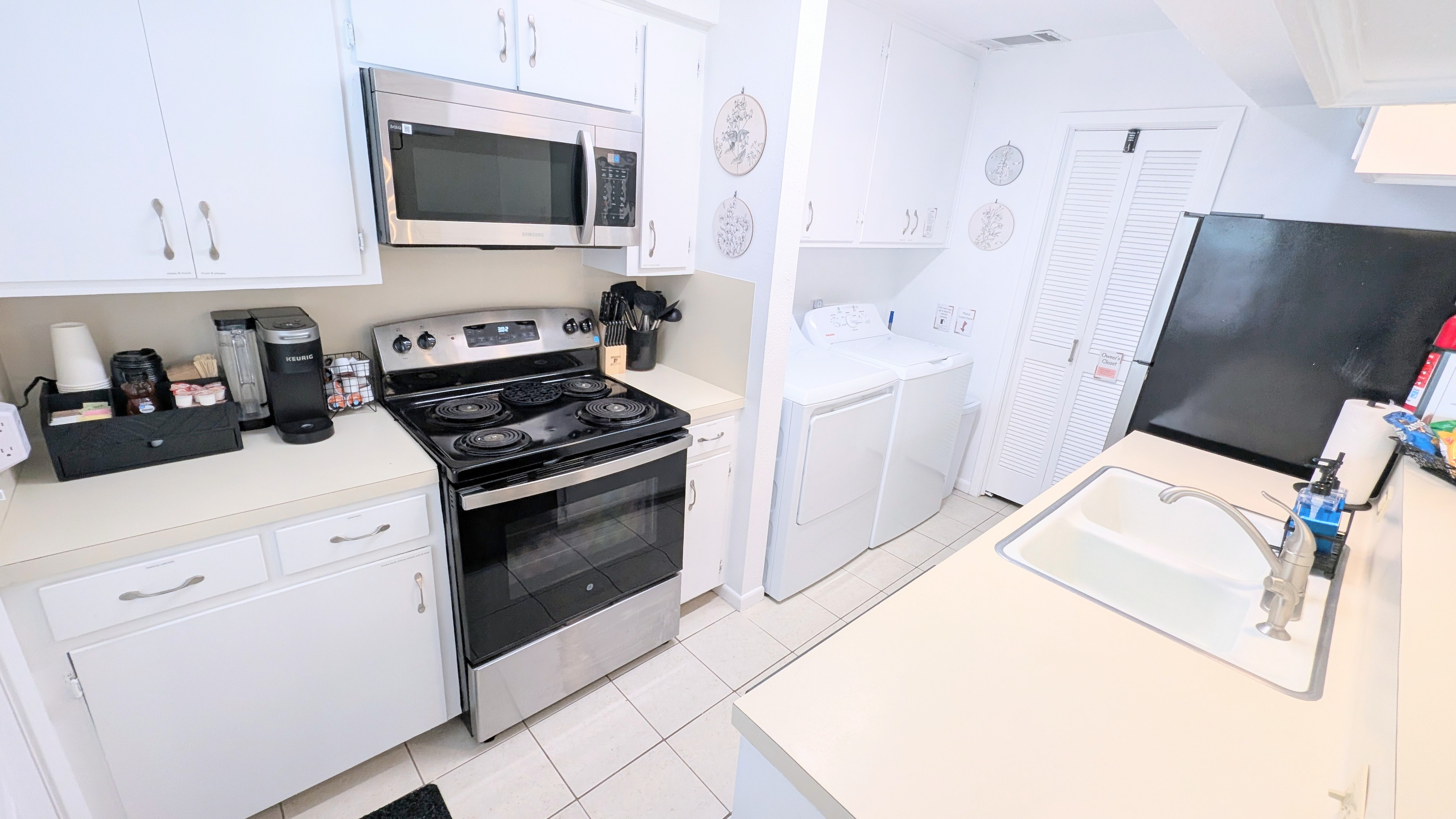 This fully equipped kitchen includes an electric stove and oven, along with a microwave for added convenience.