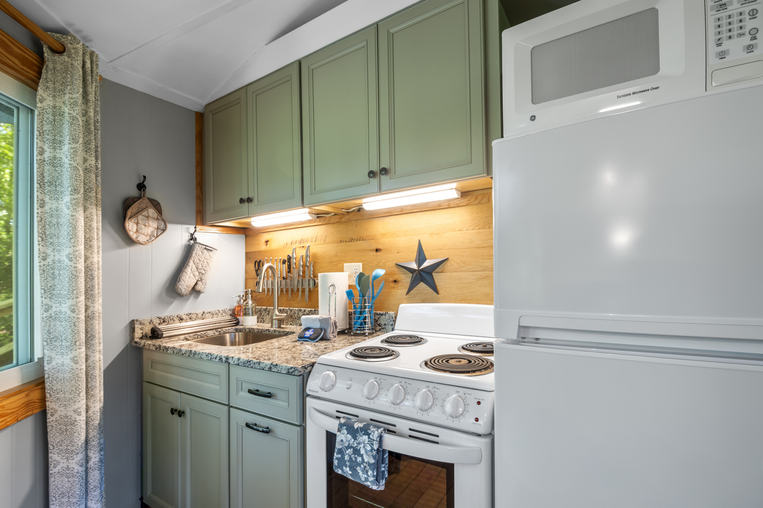 Fully equipped kitchen featuring modern appliances, granite countertops, and stunning mountain views.