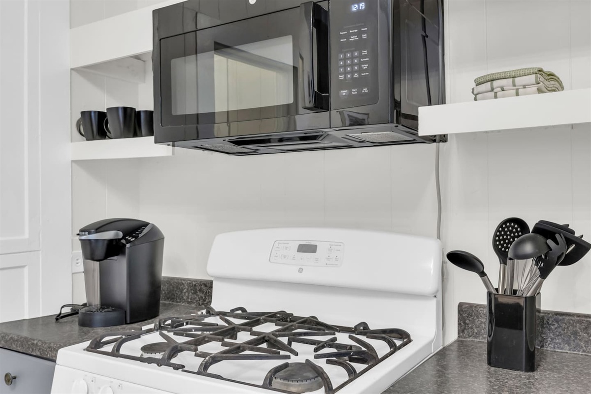 Kitchen with Keurig coffee maker, microwave,  gas range and modern appliances.