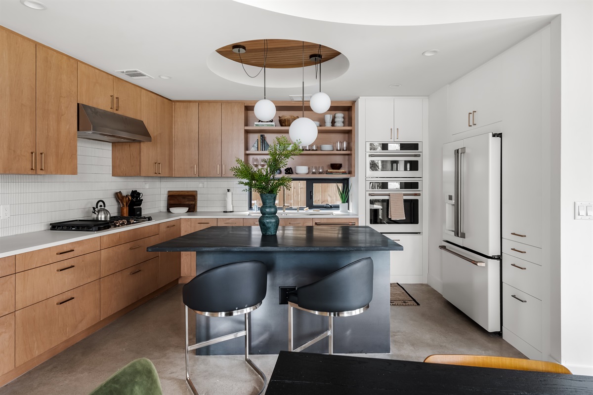 Bright, modern kitchen with ample counter space and seating—perfect for cooking together or hosting meals.