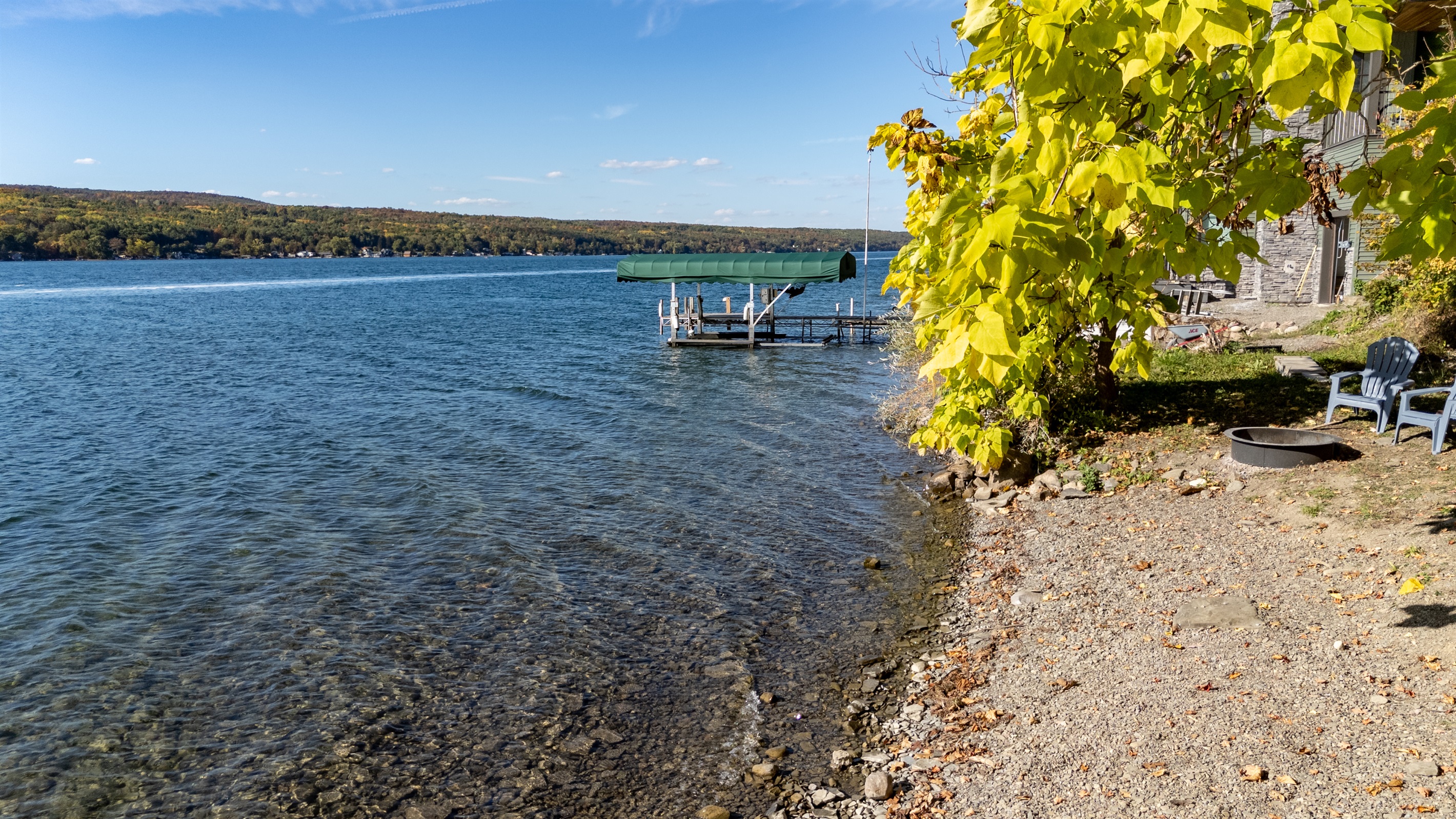 Dock and water view with tree canopy overhead — lakeside peace.