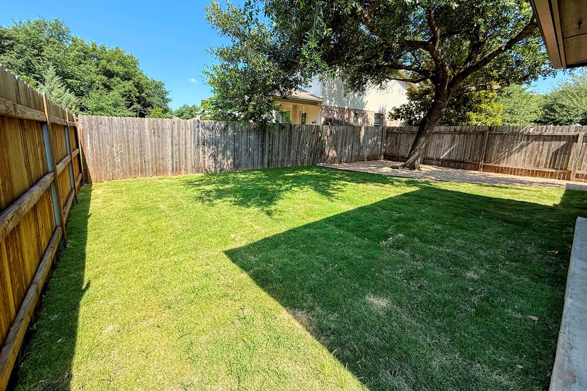 Another view of backyard with recent real grass and gravel added