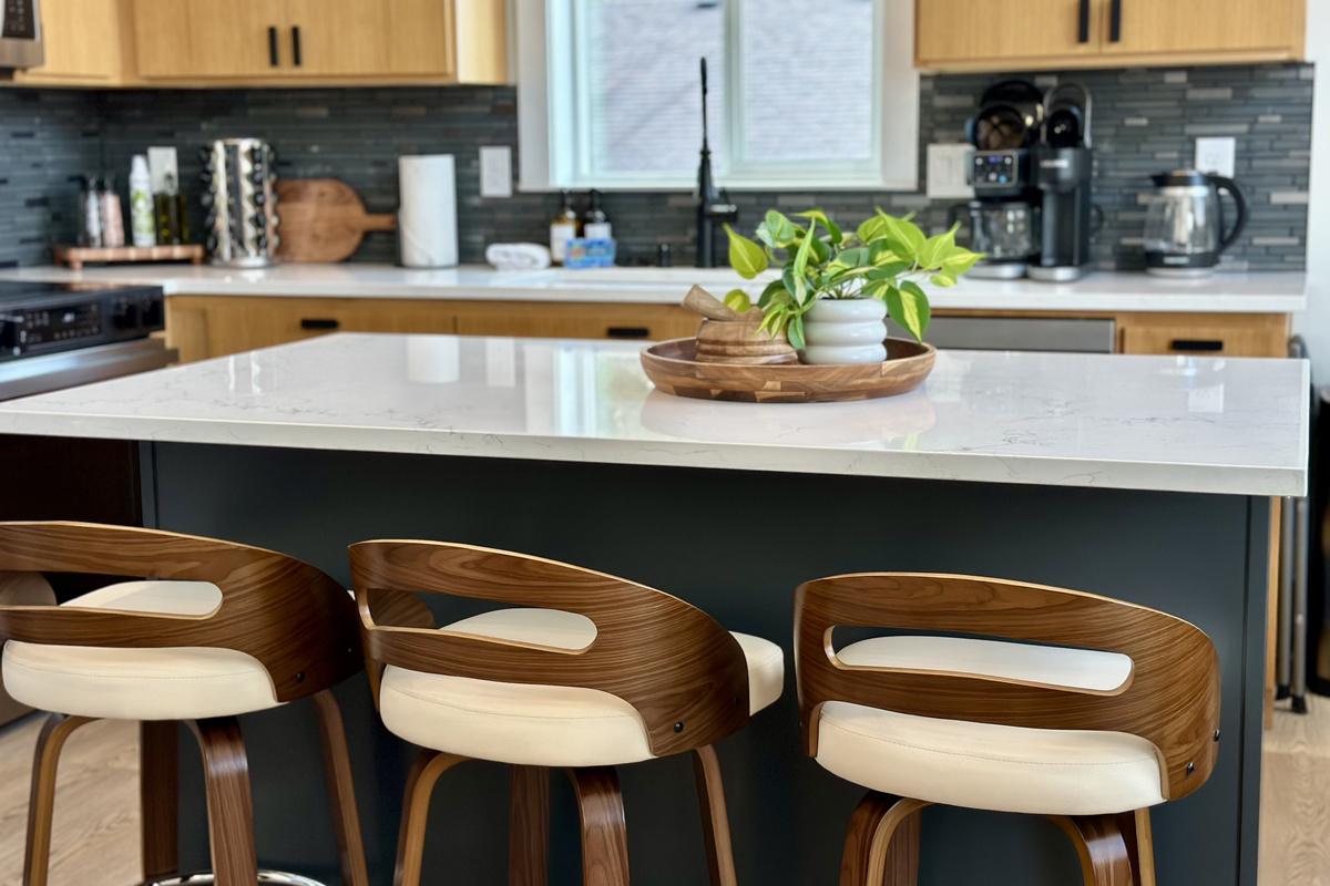 Grab your coffee at the island before anyone else is up — three stools, quiet morning light, and the coffee station just a step behind you.