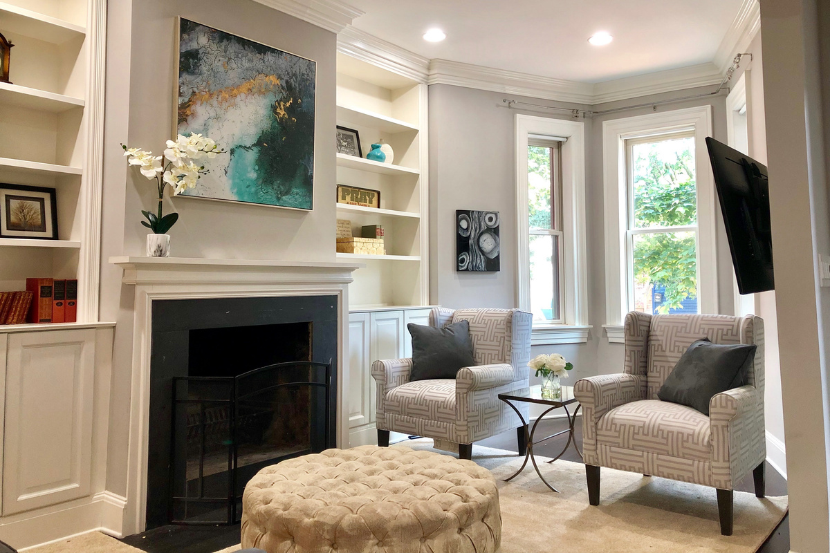 Step inside this elegantly styled living room with custom built-ins, cozy accents, and beautiful natural light to welcome you.