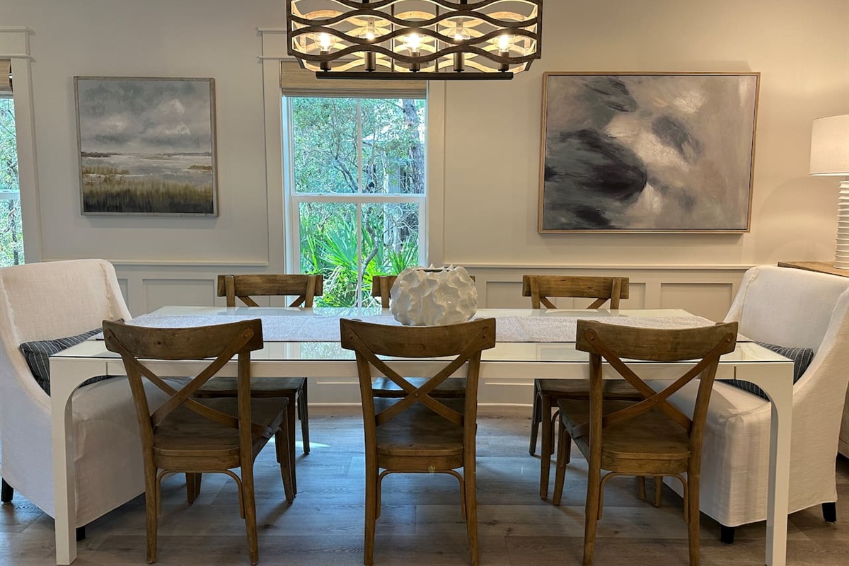 Dining area with seating for up to eight guests, there is also a kitchen counter with seating up to four guests