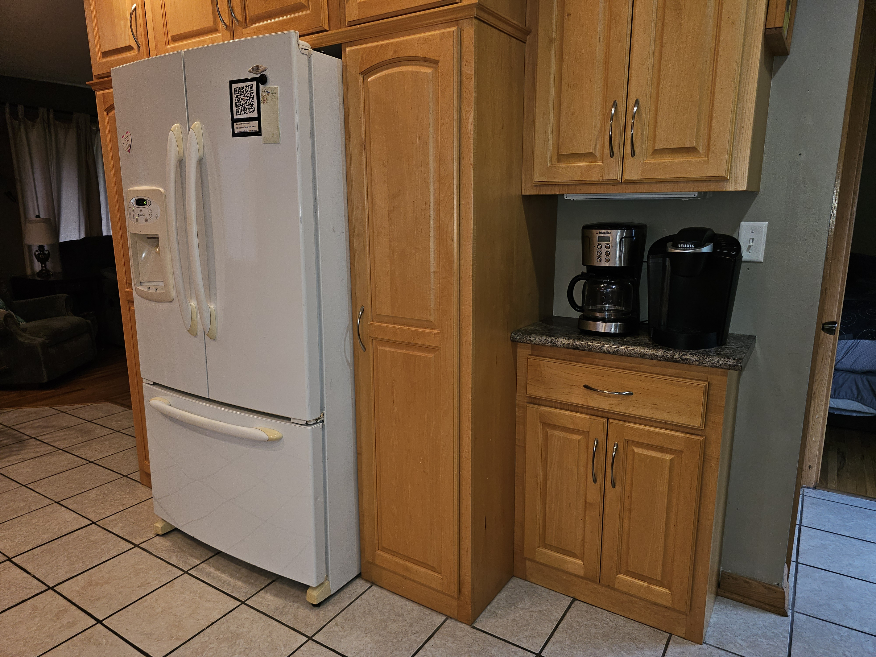 Two different types of coffee makers, full refrigerator