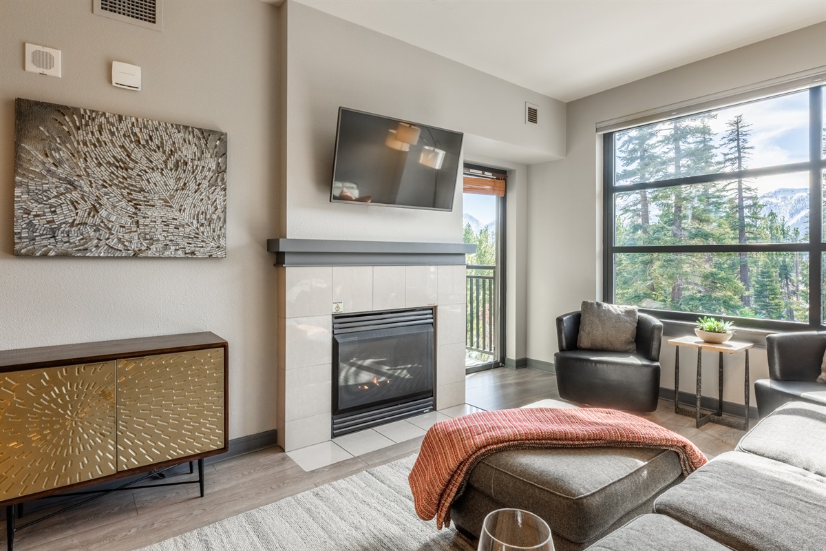 The large glass door allows natural light to flow through the living space and out to the balcony beyond.