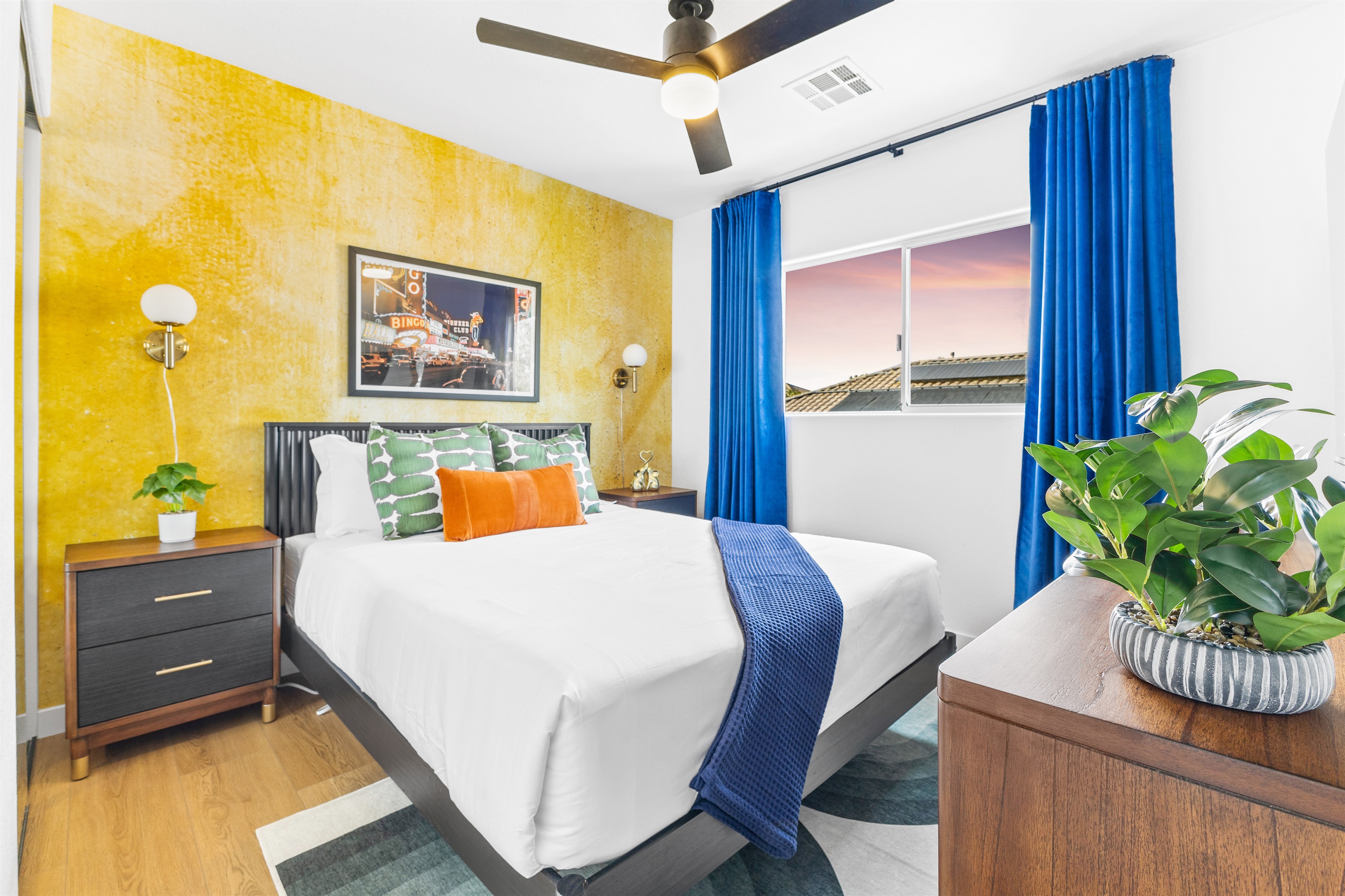 A queen-sized bed, dresser, fantastic accent wall, velvet curtains, and a 55" 4K TV are the hightligts of this bedroom upstairs. - Adventure Awaits