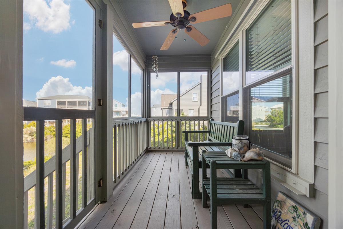Relax on the porch overlooking the pond—quiet Topsail Beach mornings.