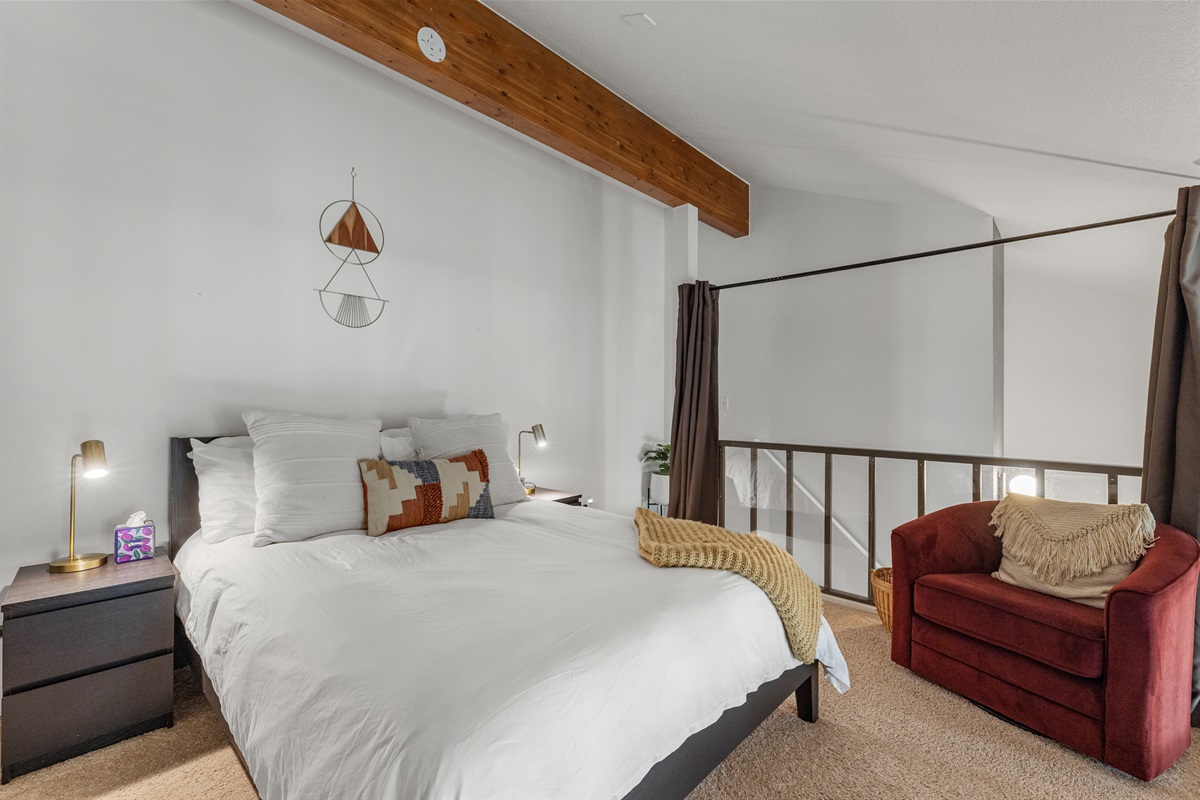 Loft with queen bed and curtains for light and privacy