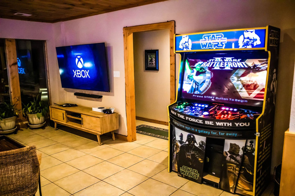 Game room with a multigame arcade and Xbox on the big screen, Tanasi Lodge