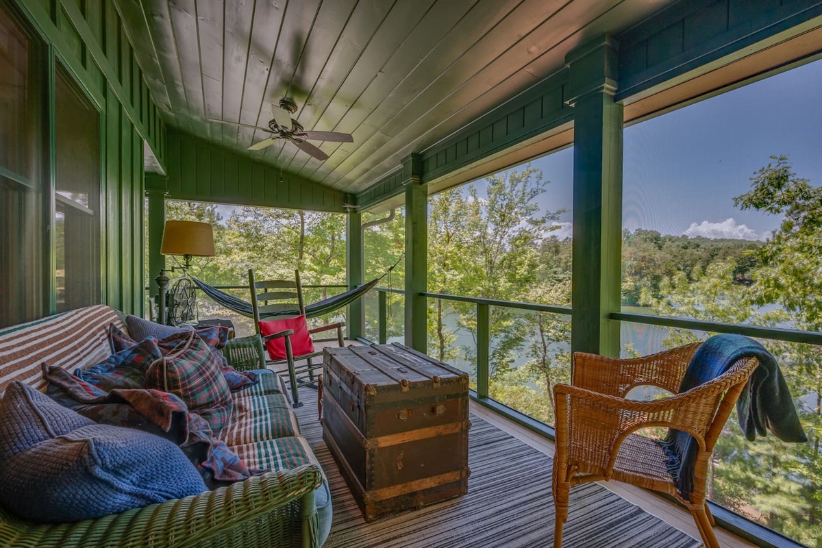 Screened in porch overlooking the lake from the main level of the home