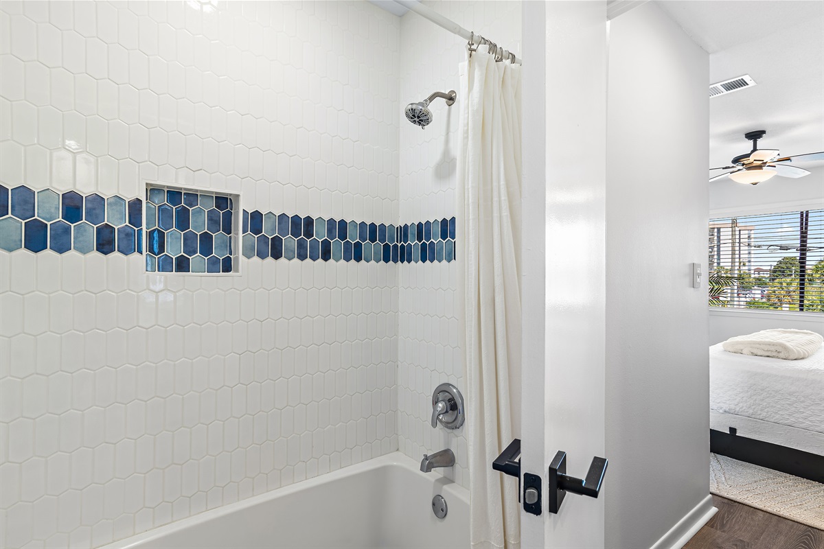 3rd Floor - Bedroom 2: King bed, ensuite bathroom with remodeled shower/tub combo, view of Scenic Gulf Drive, Smart TV (Sleeps 2)