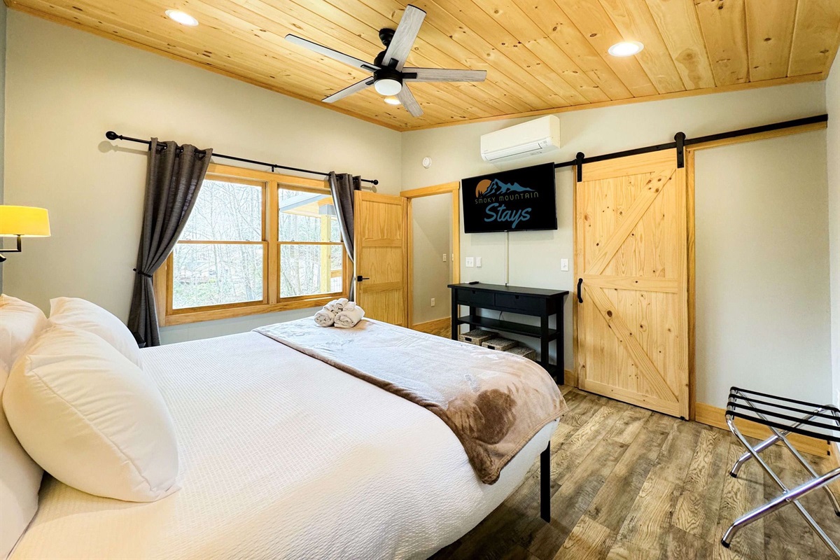 the master bedroom is complete with a smart TV and Luxurious King bed and bedding.