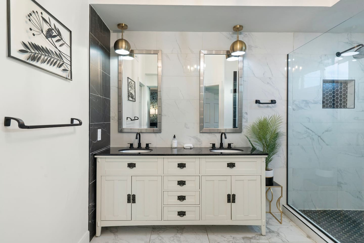 Dual vanities and designer lighting bring a boutique-hotel feel to daily routines.