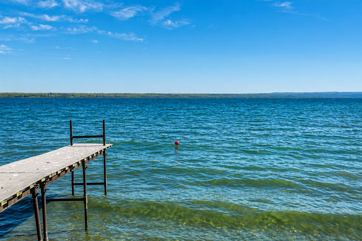 Peaceful lakefront views stretch for miles — perfect for morning coffee or sunset swims on your private dock.