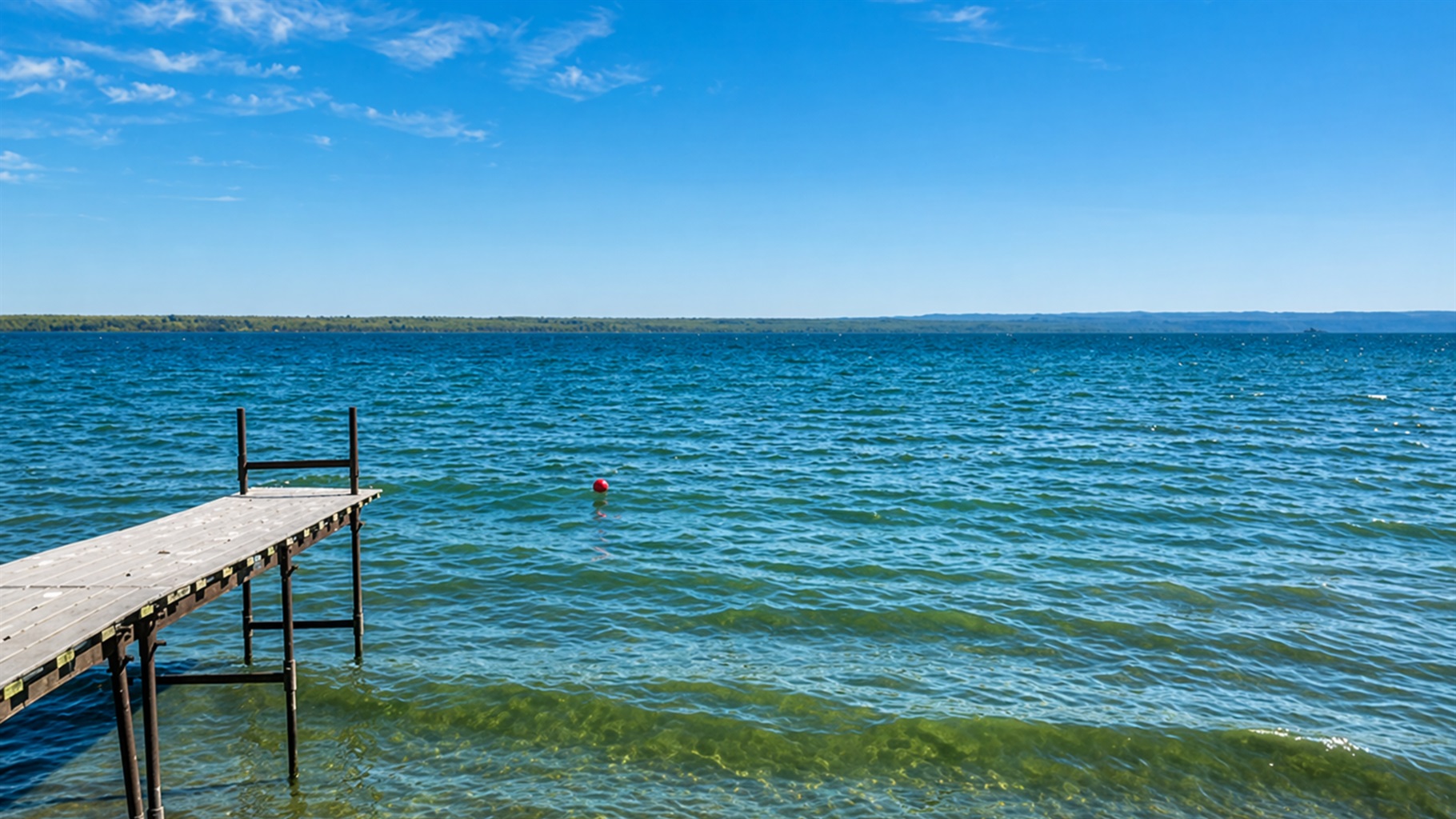 Peaceful lakefront views stretch for miles — perfect for morning coffee or sunset swims on your private dock.