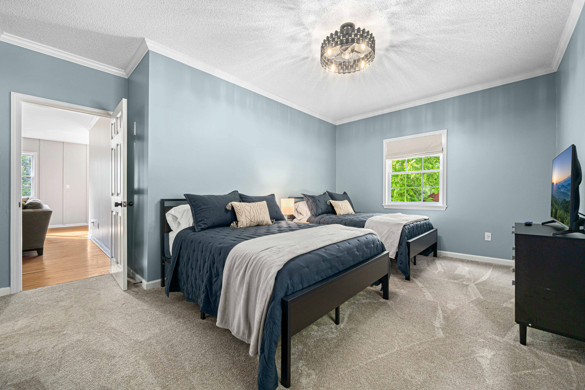Charming Bedroom: Bright and airy retreat with twin beds and a view of the lush outdoors!