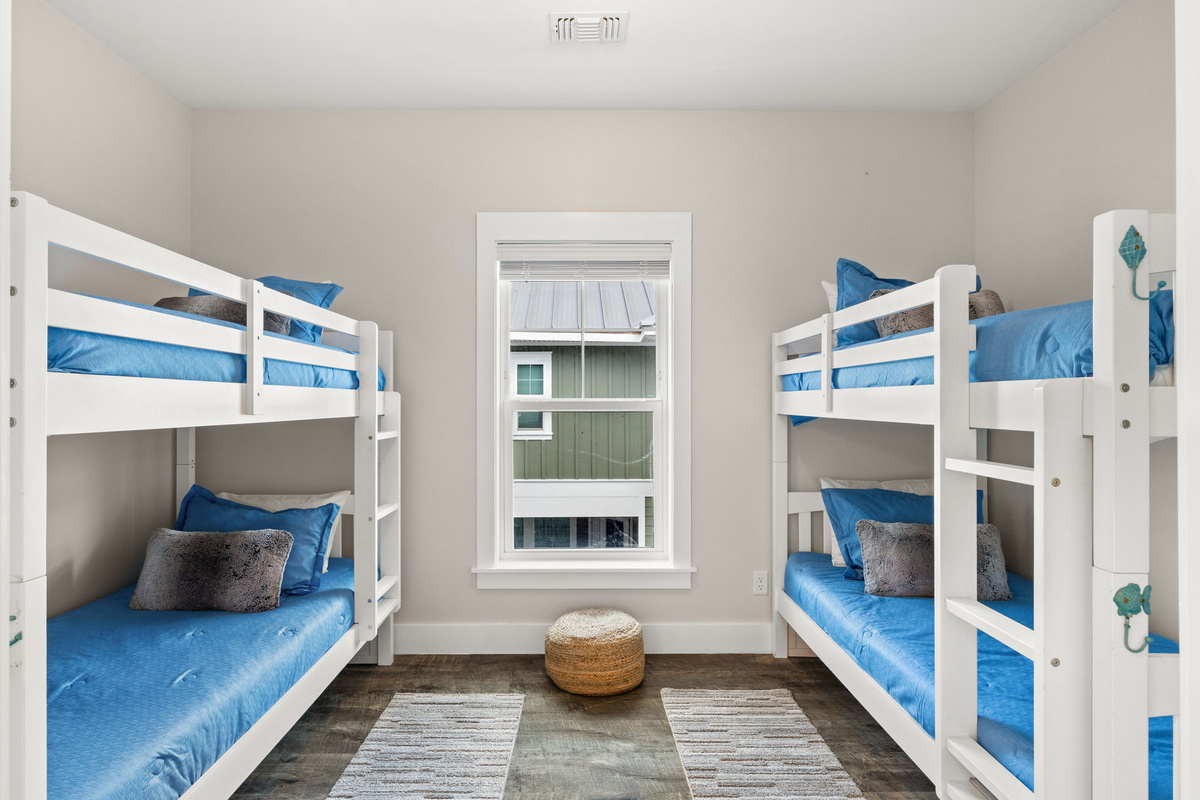 Fun bunk room with two twin-over-twin bunks — perfect kids’ beach vacation space