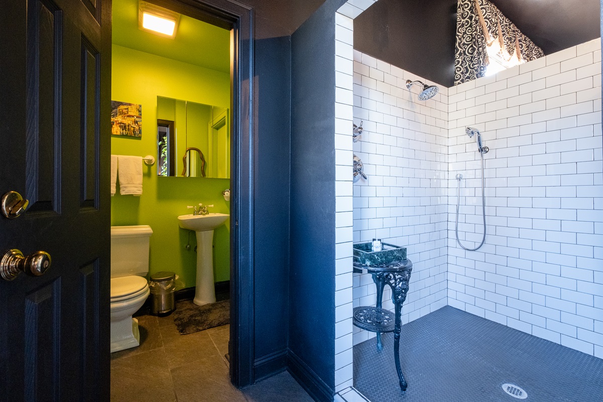 Private bathroom with walk-in shower and bold, modern tilework.