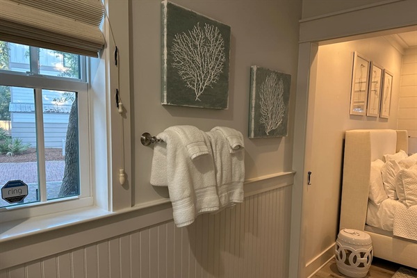 First-floor king suite bathroom with double vanity and marble shower.
